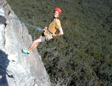 The Watagans Abseiling and Climbing day allows climbers like the one shown here go both up and down the cliff