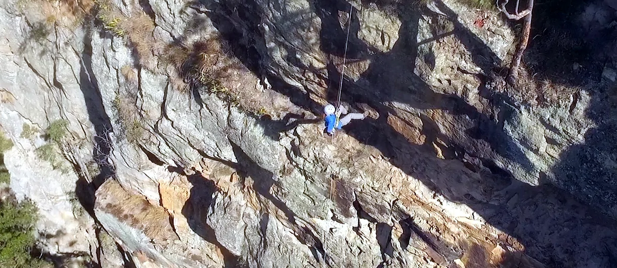 Abseiler is half way down a massive cliff on the Newcastle Abseiling Adventure