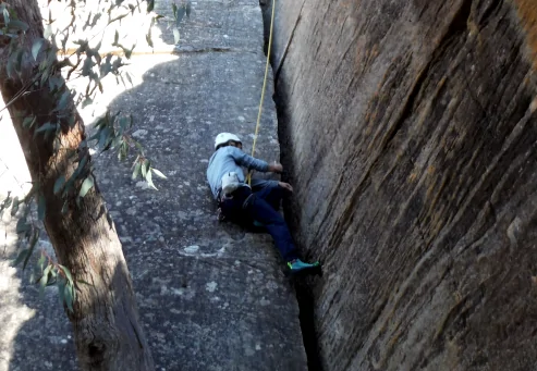 NSW Abseiling Experiences will allow anyone to climb up a cliff like this person is doing.
