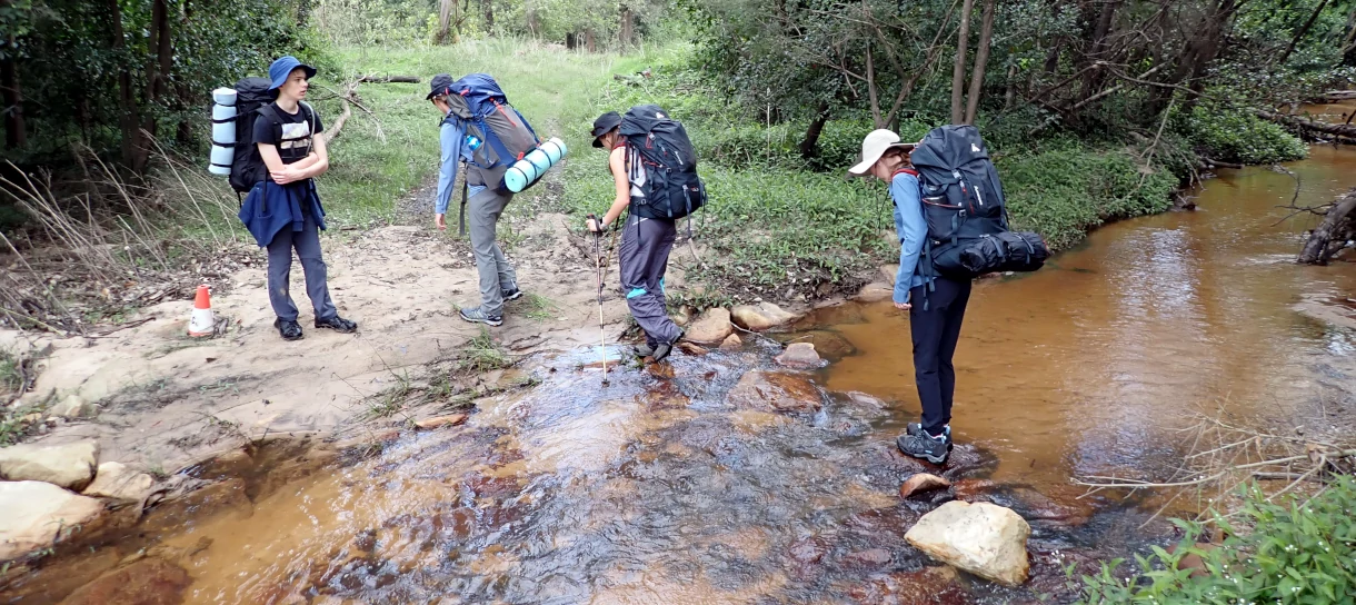 During the Silver Bushwalking Award a group of hikers are crossing a stream
