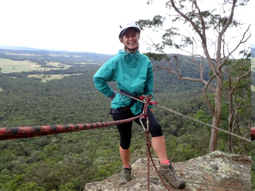 A solo abseiler standing on top of the cliff during the Lake Macquarie Abseiling Adventure