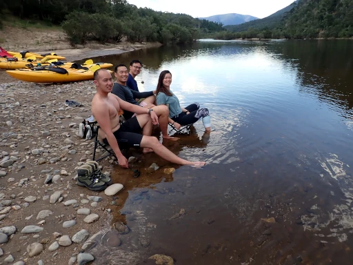 People sitting in the river on chairs relaxing during a Snowy River Kayak Adventure