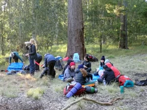 A group of hikers are sitting eating their lunch during the Gold Bushwalking Award Journey
