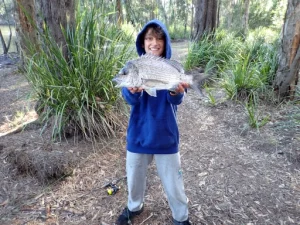 students get the chance to catch a big fish like this one on the Pack and Paddle School Camp