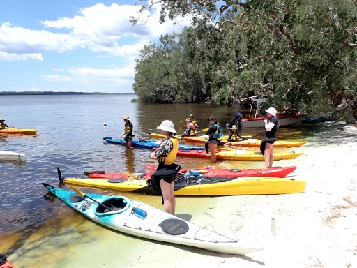 Merewether High School Kayaking Camp photo showing students standing on a beautiful Myall Lakes beach.
