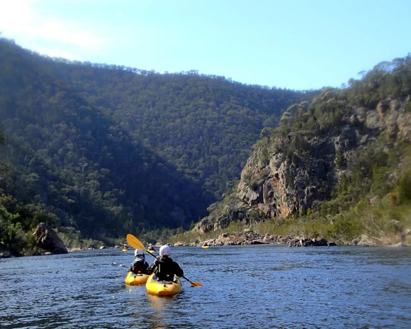 Paddling the Snowy Two people on a Guided Kayak Tours Australia journey paddling slowly down the beautiful Snowy River.